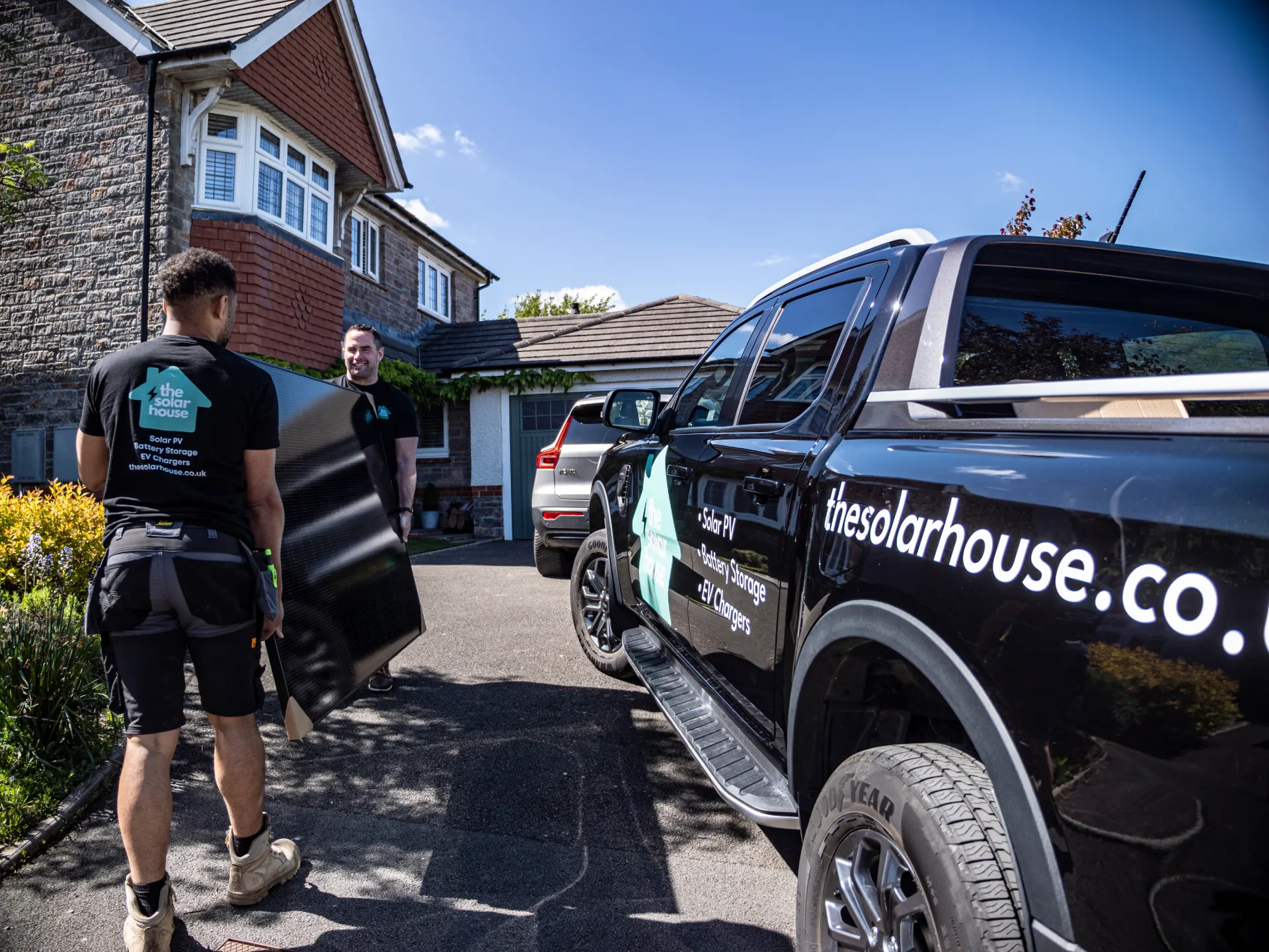 The Solar House team unloading equipment from a branded van outside a customer's home