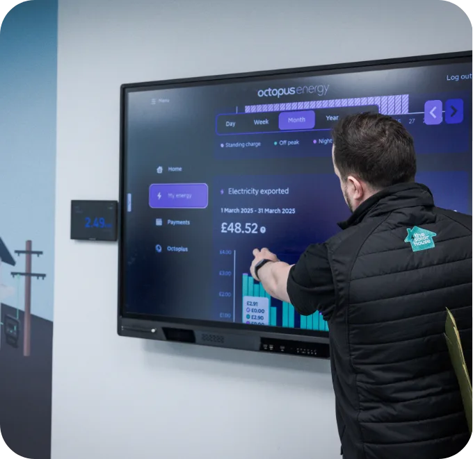 A Solar House adviser showing projected savings on the showroom screen