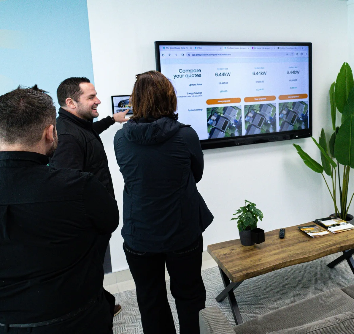 An adviser walking a customer through her solar options in the showroom