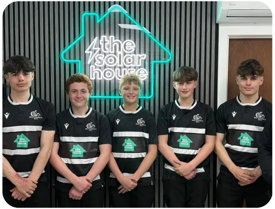 Young players in front of The Solar House neon logo