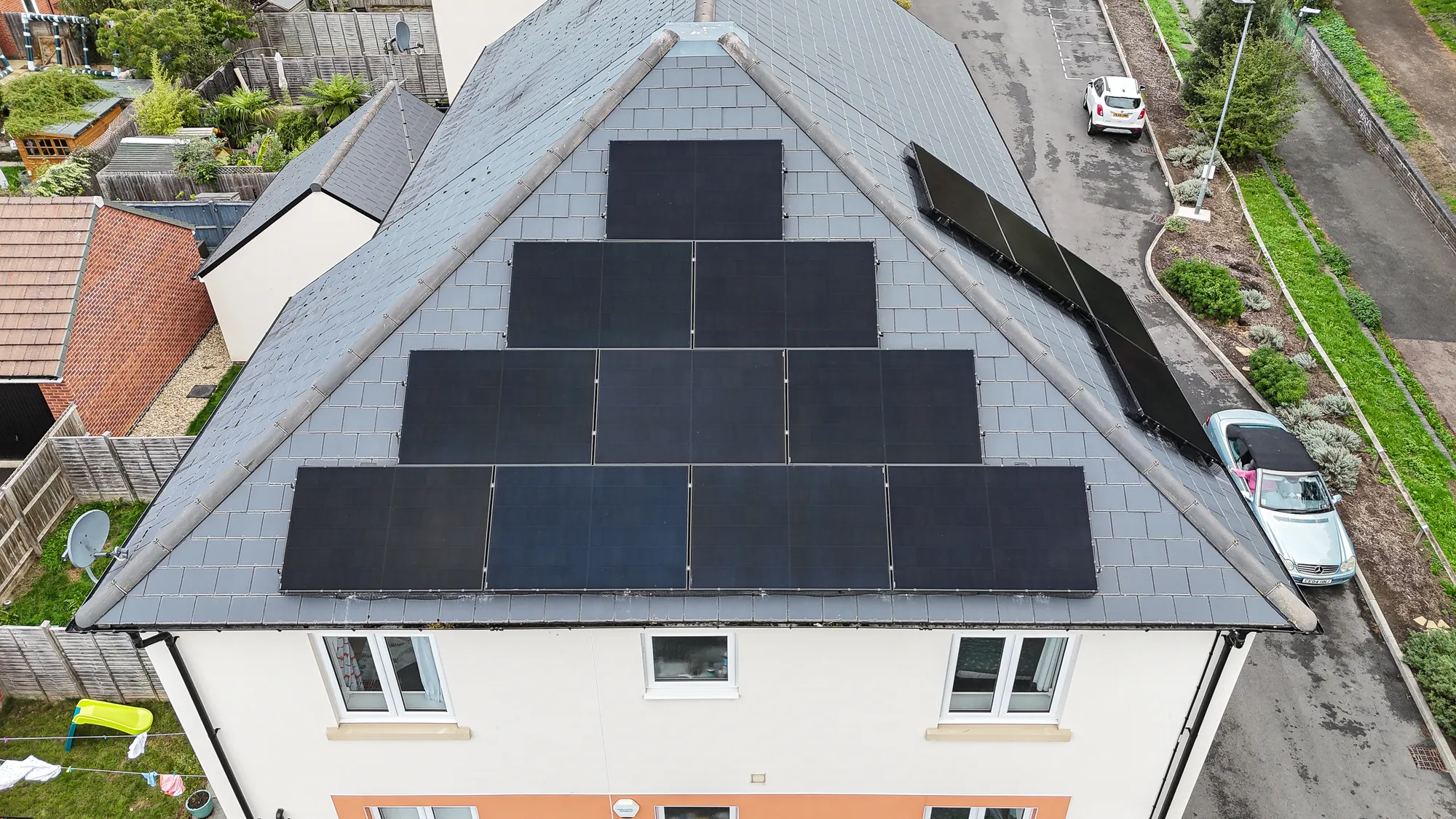 Drone view of the 14 AIKO panels on the roof of a new-build home in Cheltenham