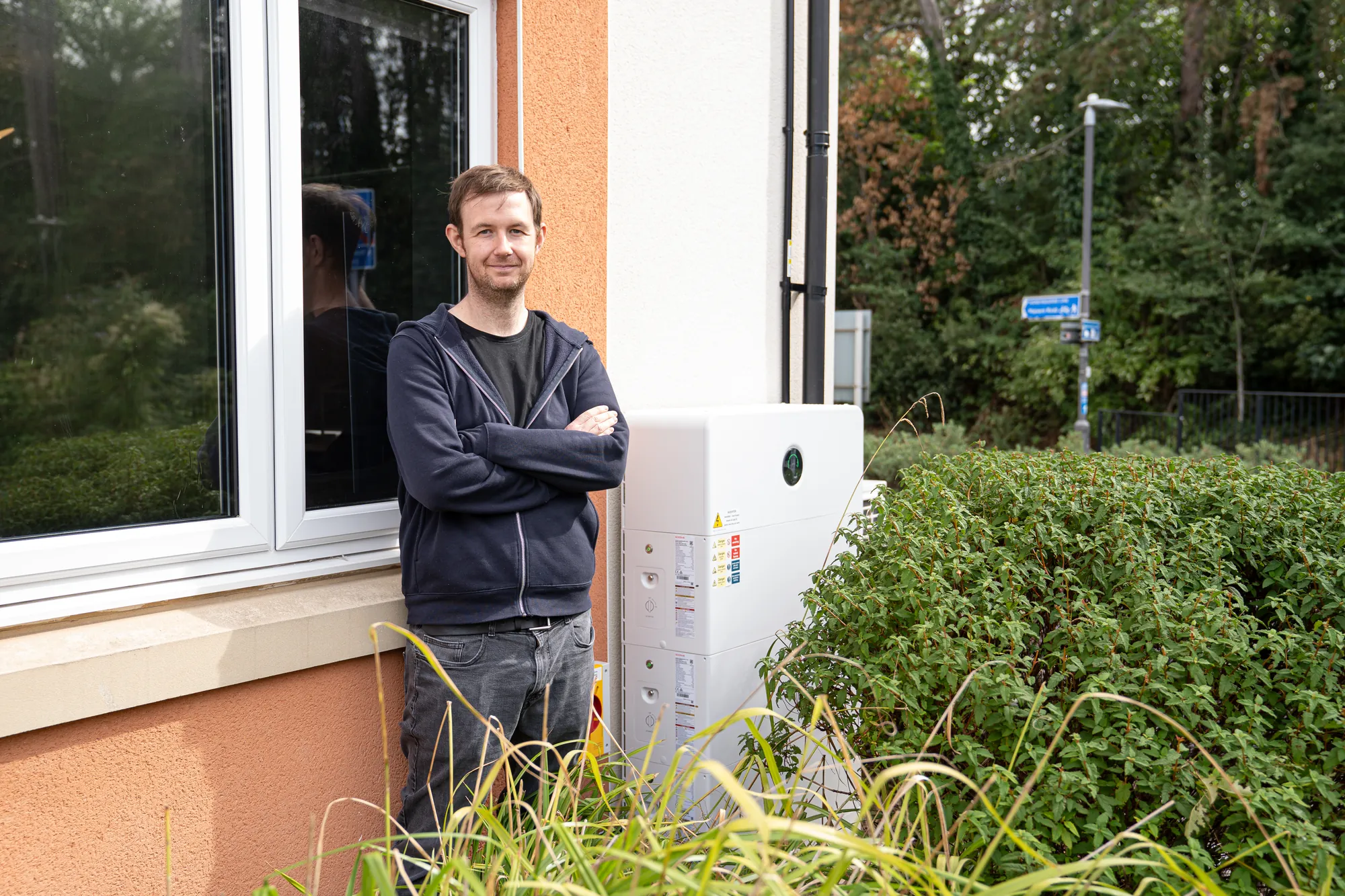 The homeowner beside his GoodWe battery