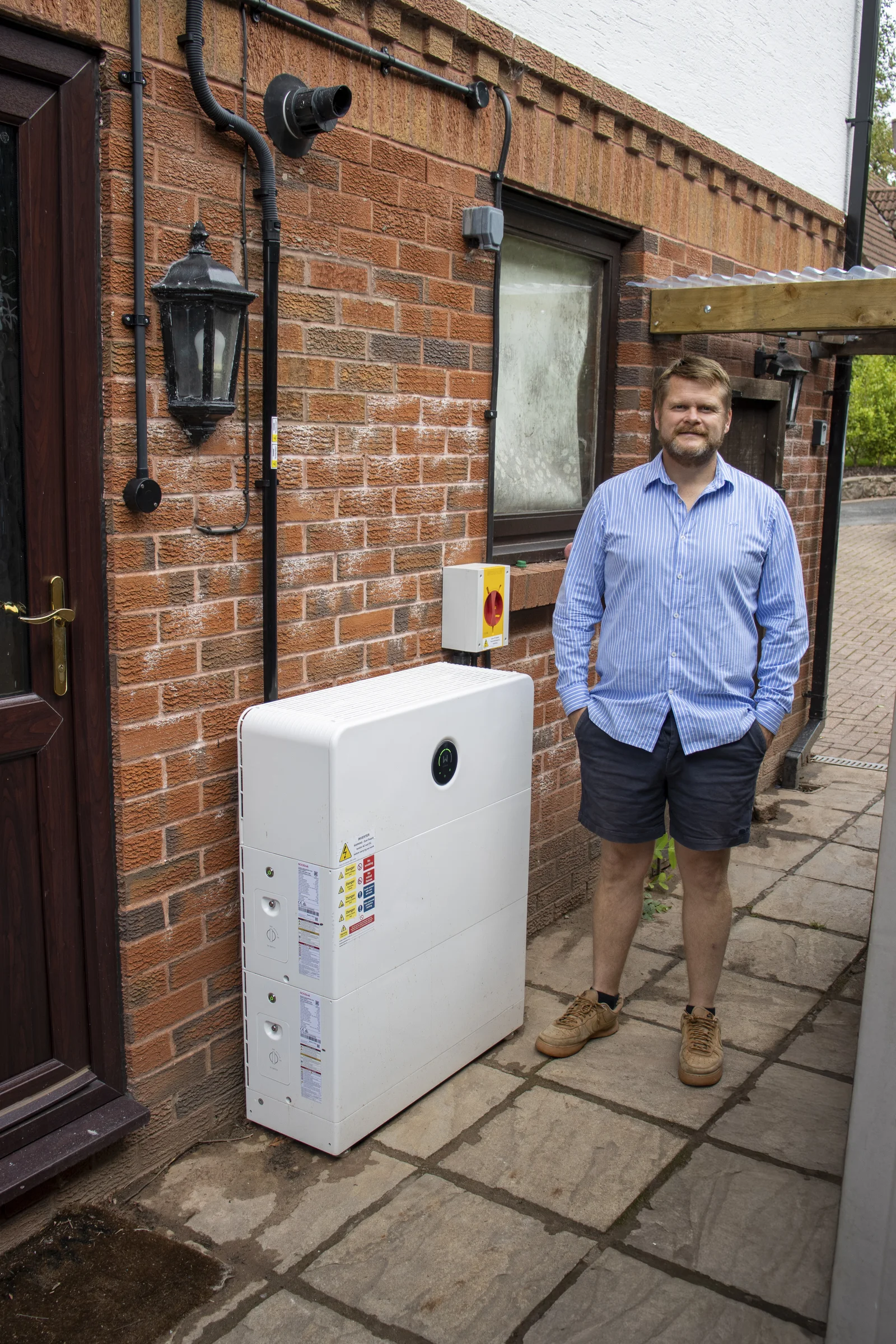 Rob standing next to his GoodWe battery system