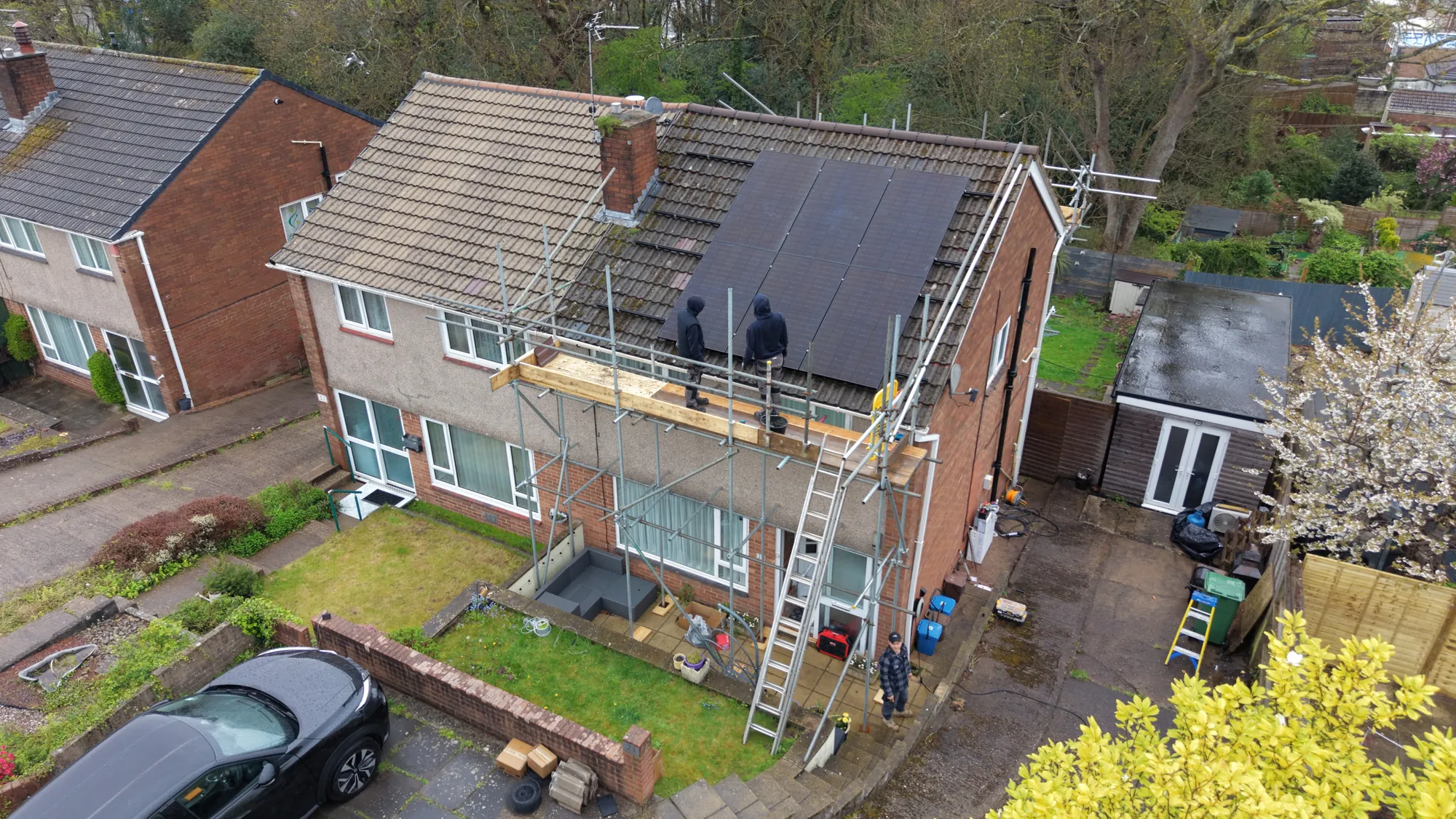 Our team fitting panels on a semi-detached house in Penylan, Cardiff, with scaffolding up