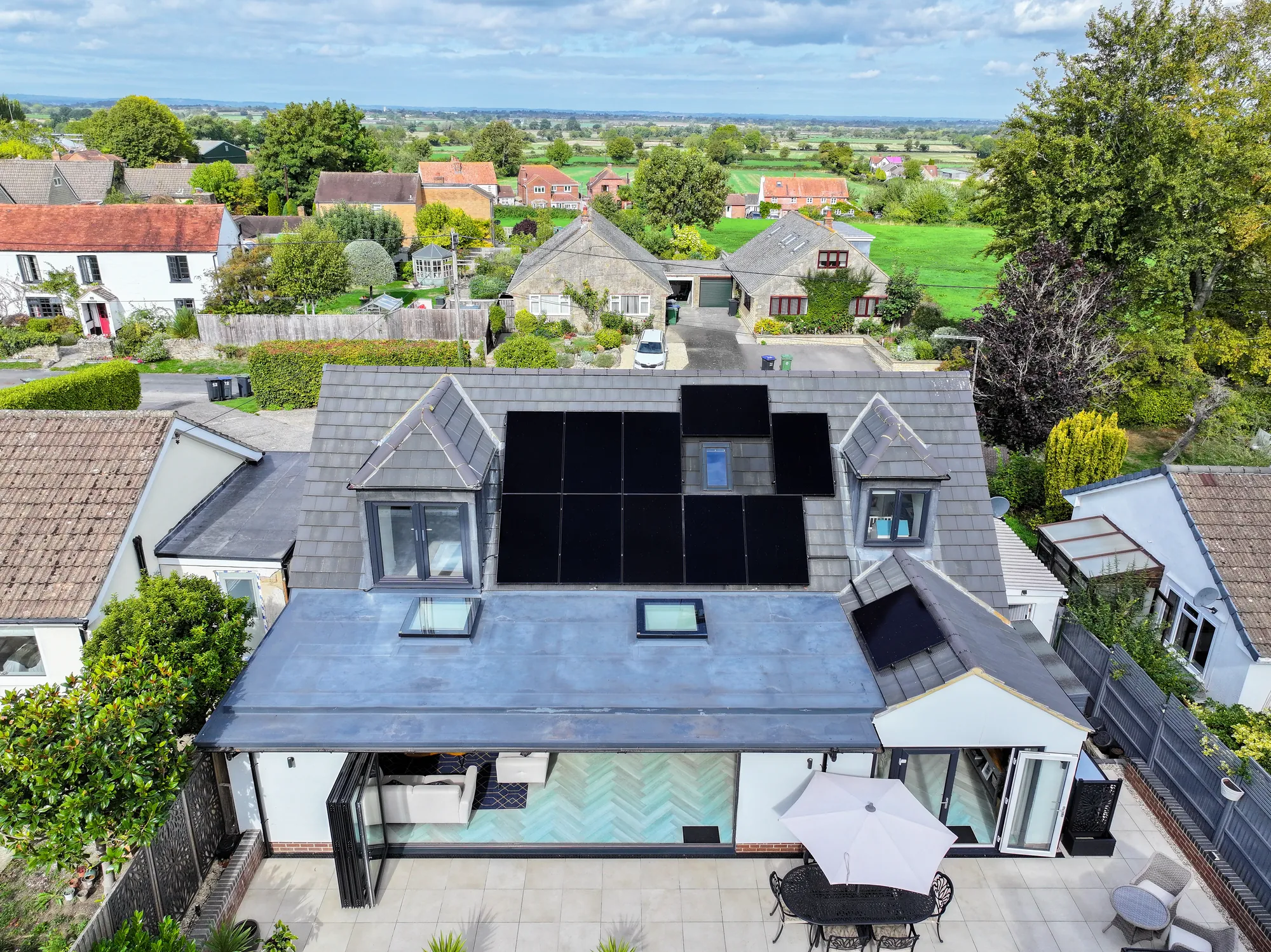 Drone view of the bungalow and the panels on the south-facing roof
