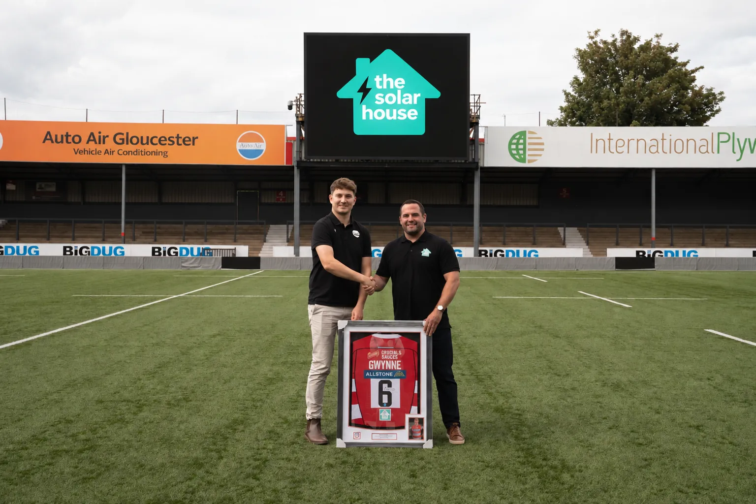 The Solar House presenting a signed Gloucester Rugby shirt on the pitch at Kingsholm