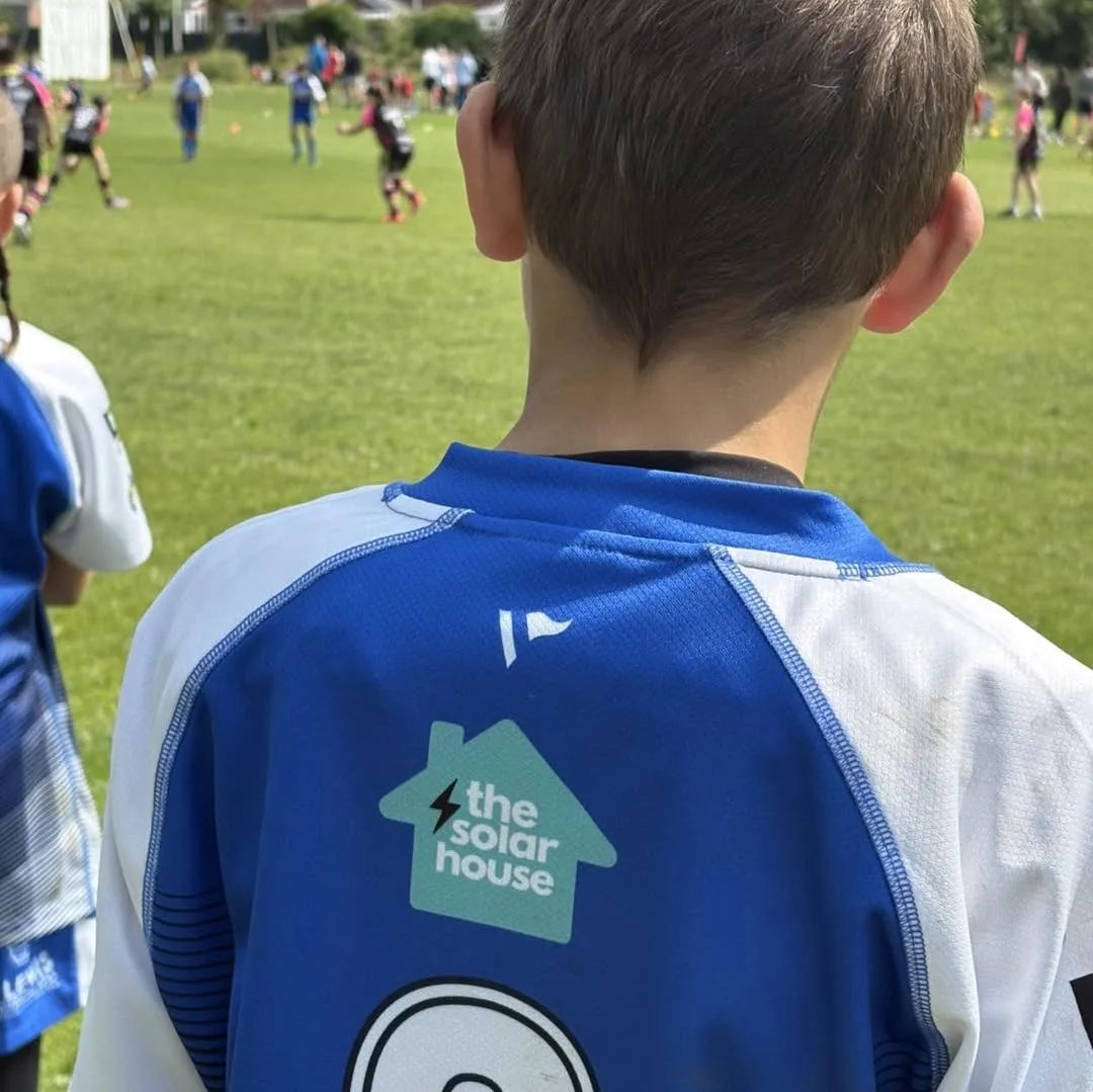 A Cardiff Blue Dragons junior wearing a shirt with The Solar House logo