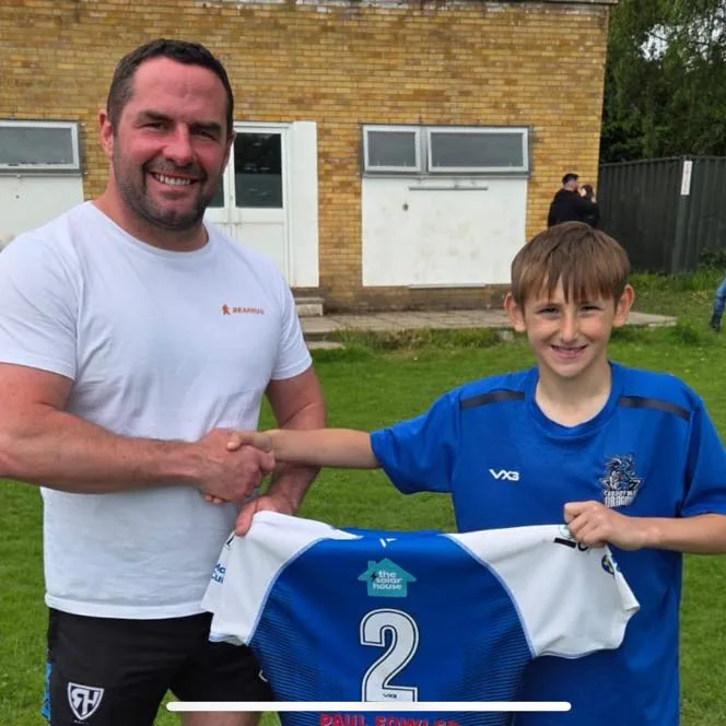 Handing over the new Cardiff Blue Dragons junior shirts