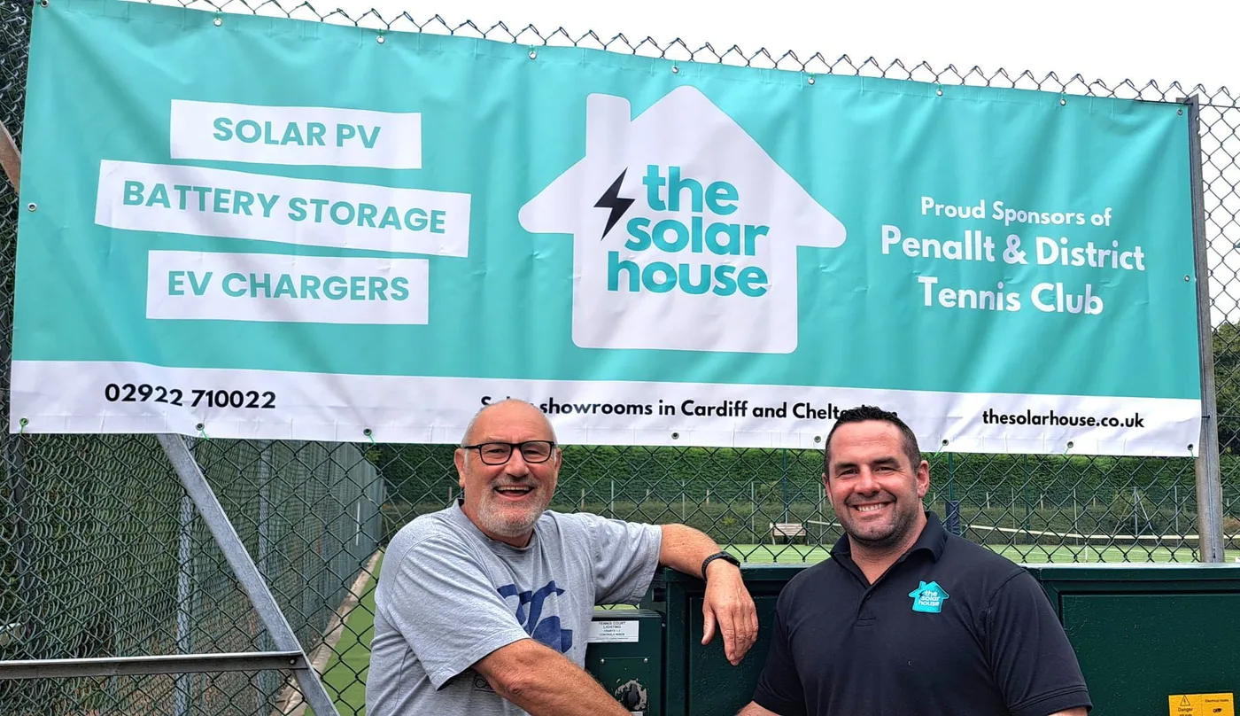 Two of the team by our banner at a local club