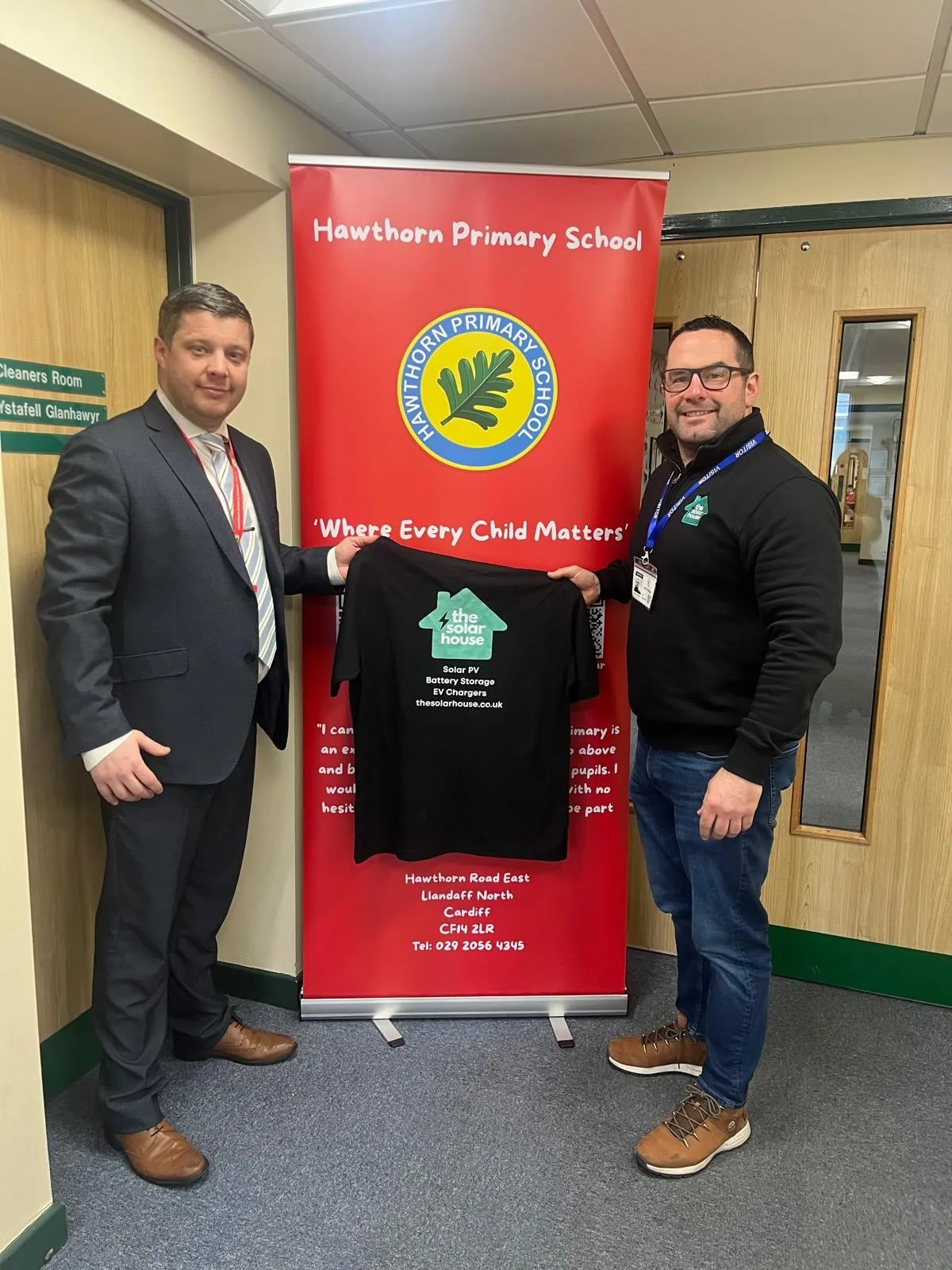 Dan and the head teacher of Hawthorn Primary School with a framed shirt