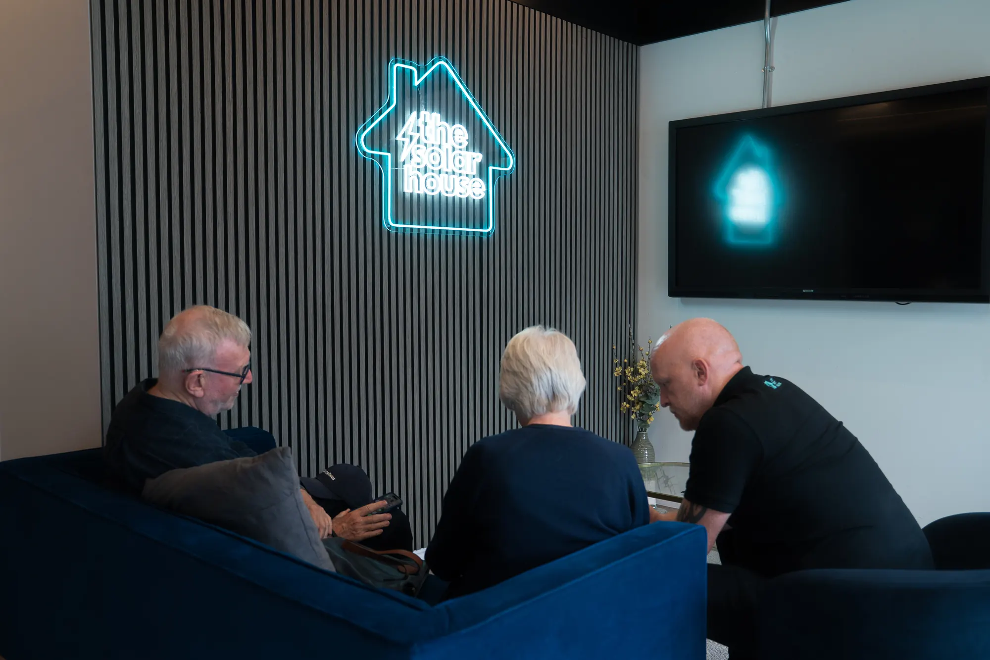 One of our team sitting down with a couple in the showroom to talk through costs