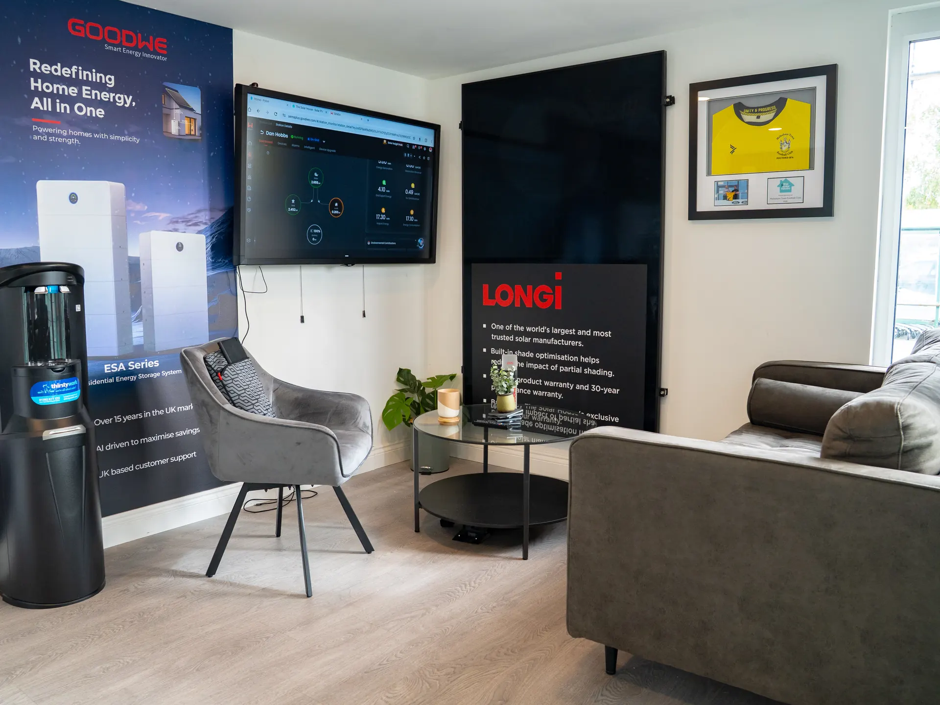 Inside our showroom: the seating area, battery displays and the screen we use to show your savings