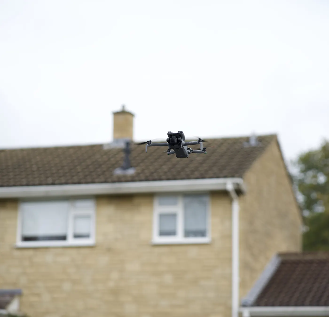 A drone surveying a house roof before a solar install