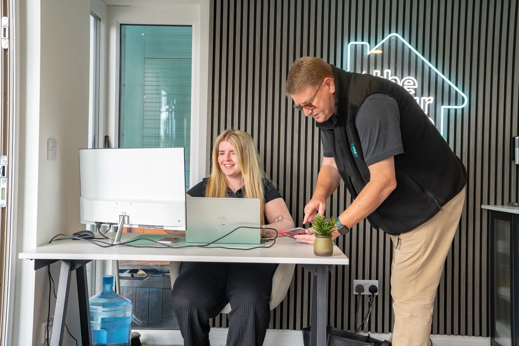 The Melksham team helping a customer at the showroom desk