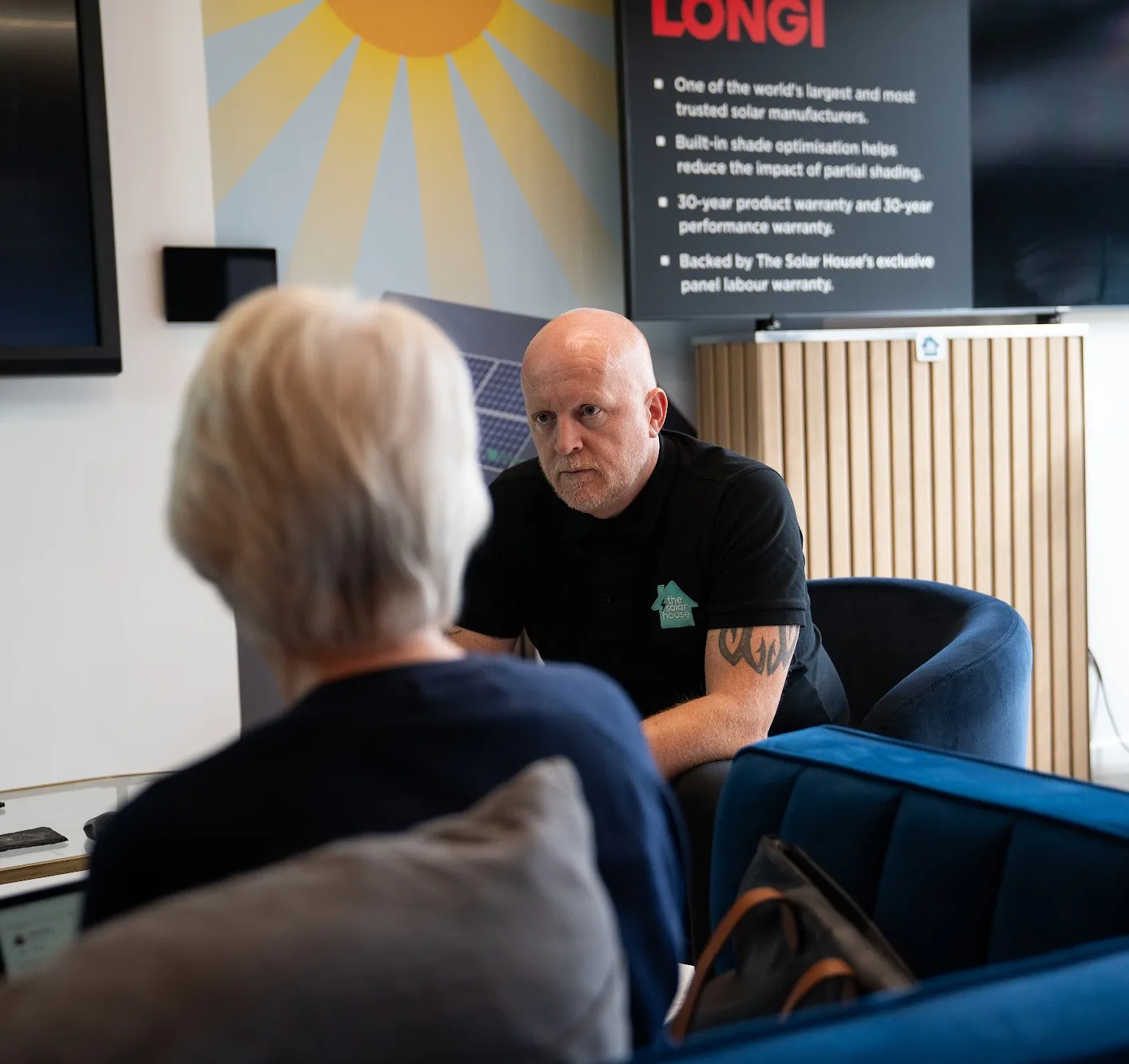 Wayne talking a customer through her options in the Cheltenham showroom